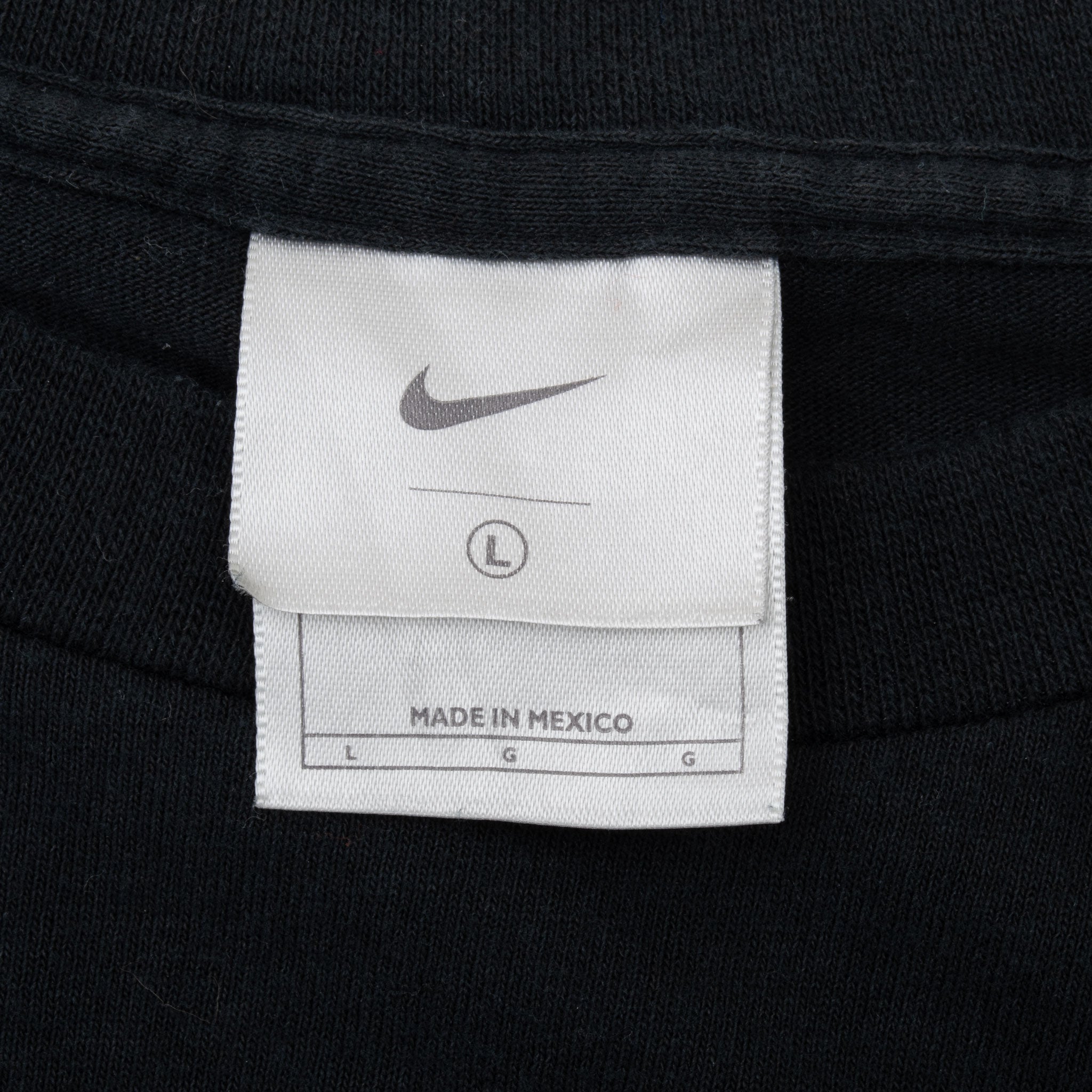 Nike neck tag showing size large and Made in Mexico label