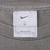 Nike neck tag on grey long-sleeve T-shirt showing size Large and Made in Mexico
