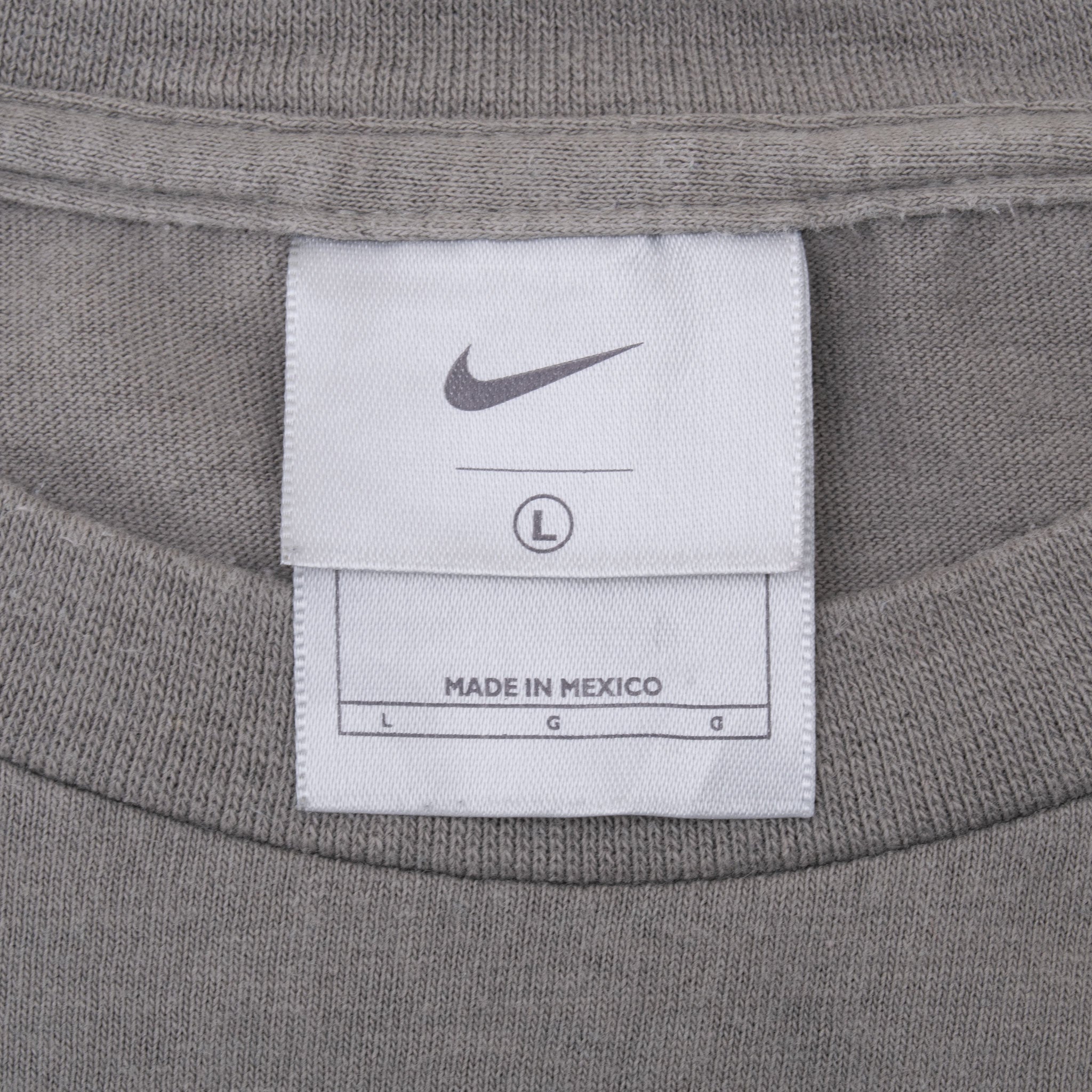 Nike neck tag on grey long-sleeve T-shirt showing size Large and Made in Mexico