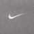 Close-up of white embroidered Nike Swoosh on grey chest fabric