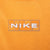 Close-up of white Nike wordmark and outlined grid graphic below back neckline