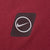 Close-up of black-and-white circular Nike Swoosh print on burgundy fabric
