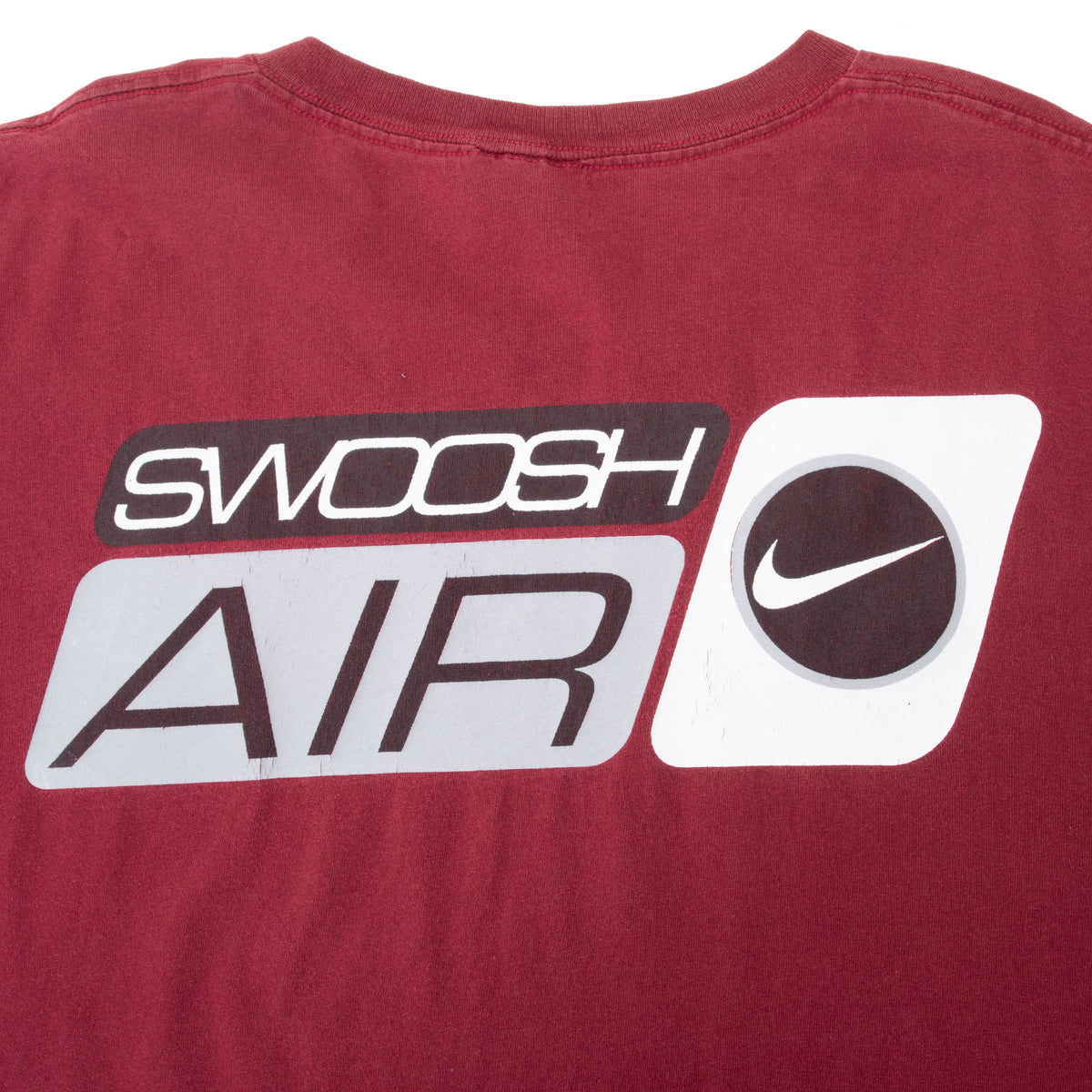 Close-up of black, white and gray Nike Swoosh Air back print on burgundy fabric