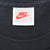 Nike neck tag with red Swoosh, size medium and Made in USA text