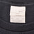 Close-up of Nike Swoosh neck tag marked XXL inside black T-shirt