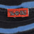 Close-up of red Yu-Gi-Oh neck label and blue-striped black collar