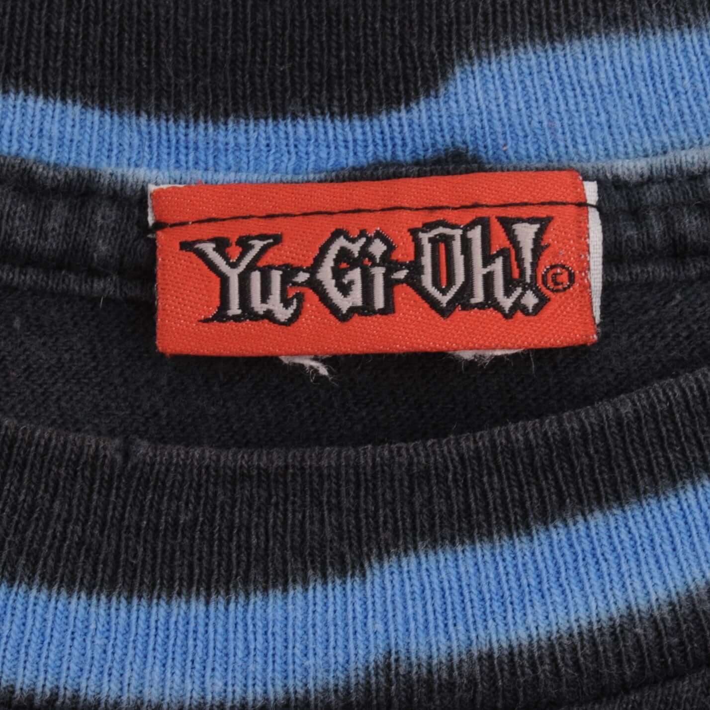 Close-up of red Yu-Gi-Oh neck label and blue-striped black collar