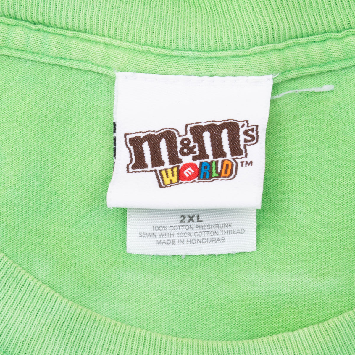 M&M's World neck tag and 2XL size label on green T-shirt