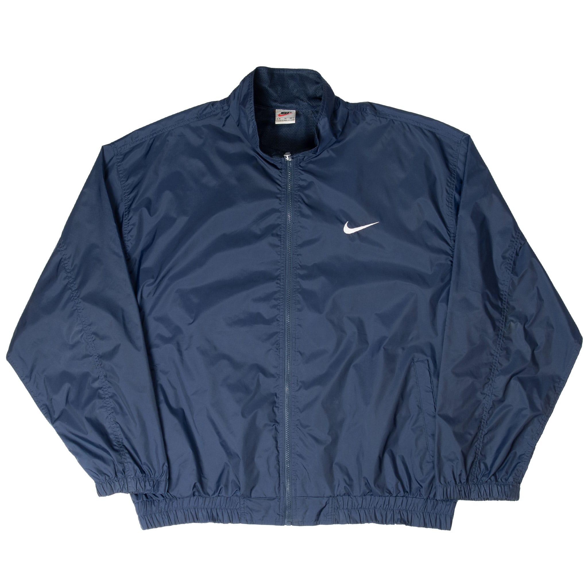 Front of navy Nike windbreaker with stand collar, side pockets and white Swoosh