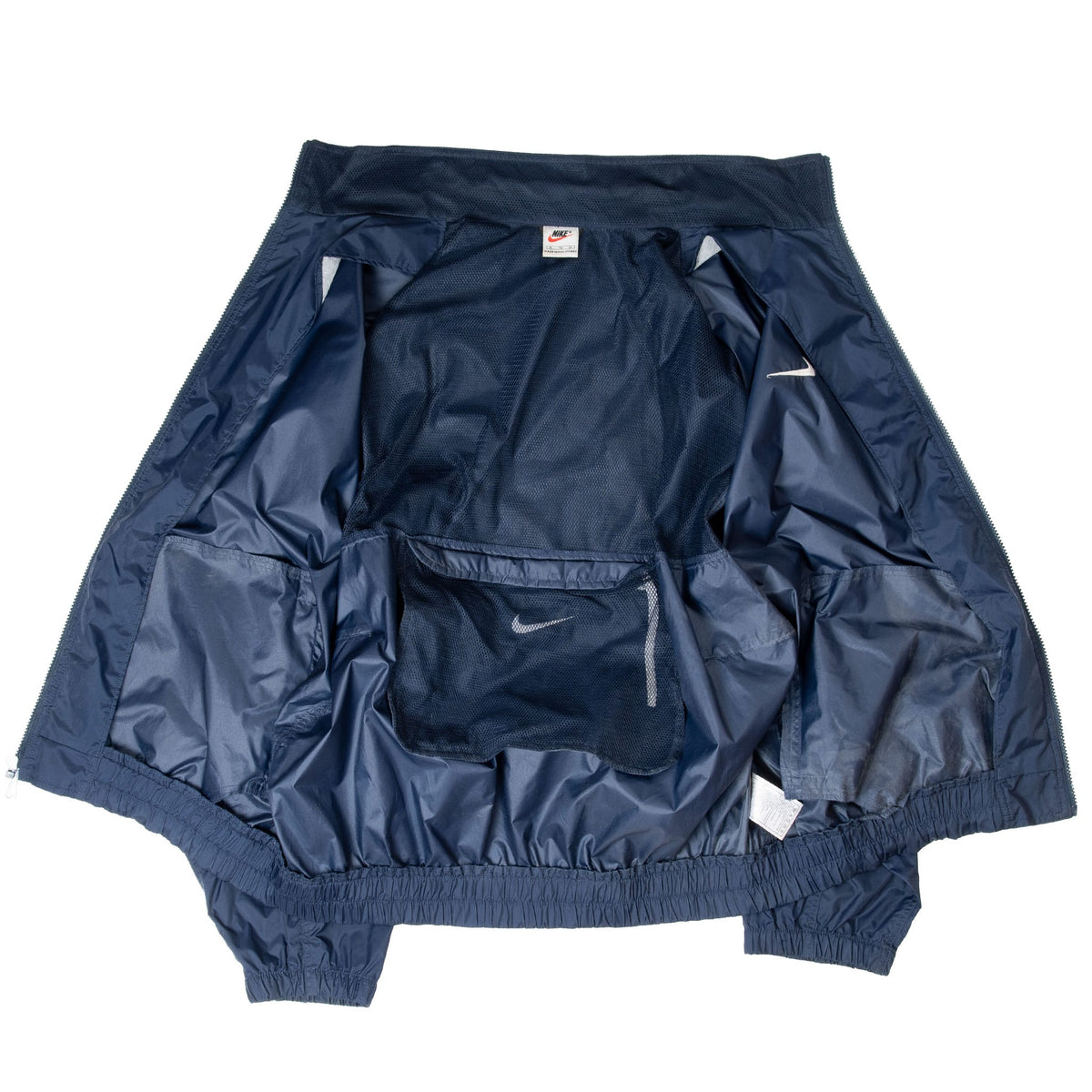 Inside of navy Nike windbreaker showing mesh-textured lining and interior pocket