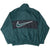 Back of green Nike windbreaker with oversized outlined Swoosh on black panel