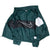 Interior view of open green Nike windbreaker showing reverse of color-blocked panels