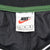 Nike neck label showing size large inside black pullover windbreaker