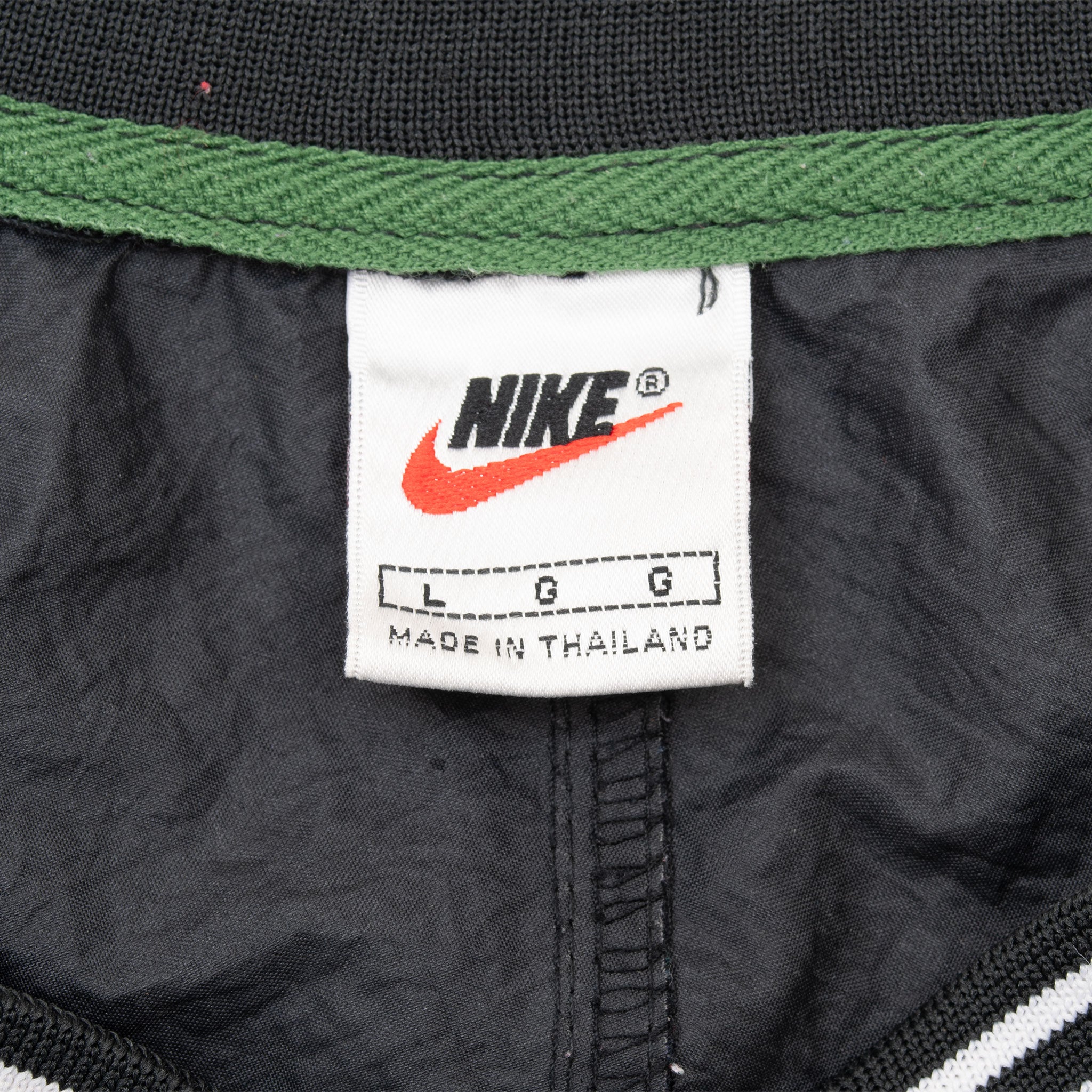 Nike neck label showing size large inside black pullover windbreaker