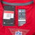 Close-up of Nike NFL On Field Dri-FIT size L neck label, hangtag and NFL shield