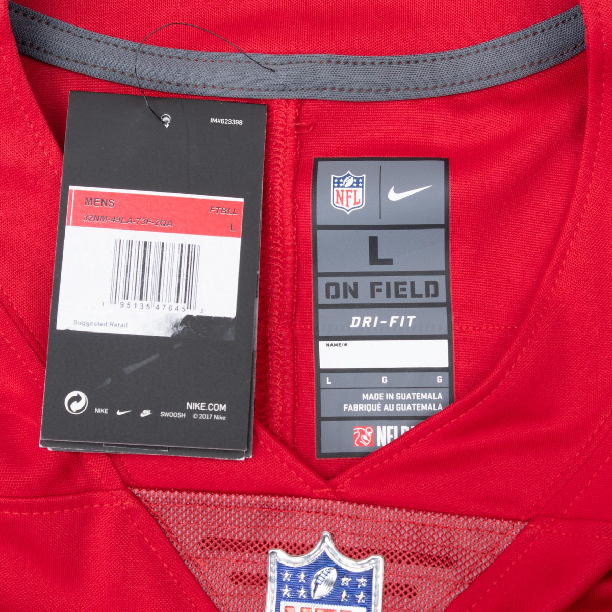Close-up of Nike NFL On Field Dri-FIT size L neck label, hangtag and NFL shield