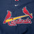 Close-up of embroidered St. Louis Cardinals birds-on-bat logo and Nike Swoosh