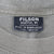 Close-up of Filson Seattle neck label inside the green crewneck T-shirt