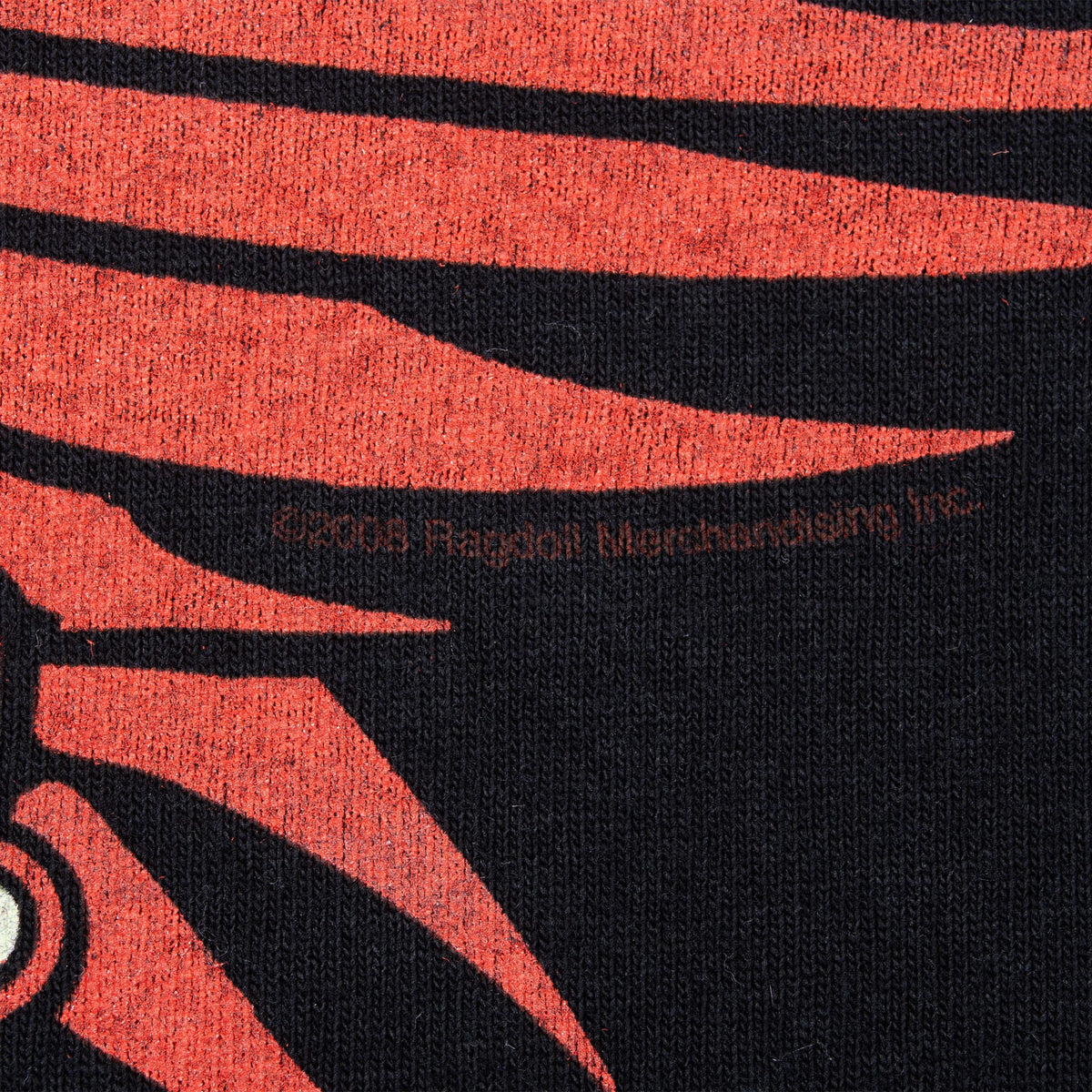 Close-up of red wing print and 2008 Rag Doll Merchandising copyright detail