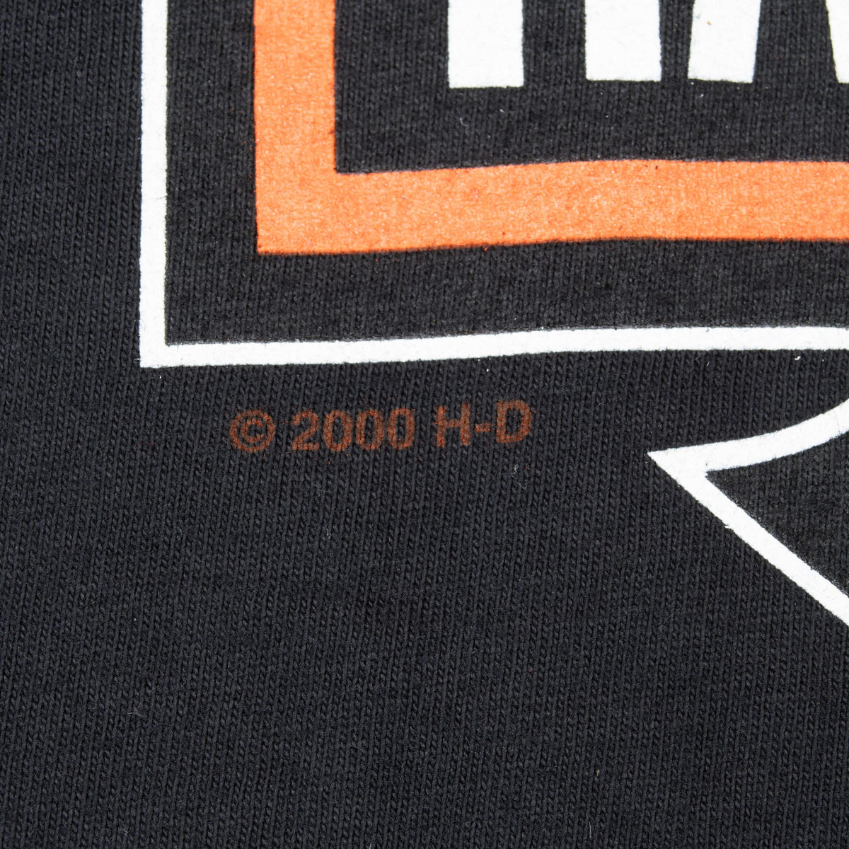 Close-up of © 2000 H-D text beneath the Harley-Davidson print
