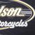 Close-up of white, yellow and gray Harley-Davidson front print on black fabric