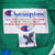 Champion neck label and size large tag inside green collar