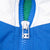 Close-up of blue quarter-zip and Champion C logo zipper pull