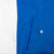 Front pocket detail on blue panel beside white color-block section