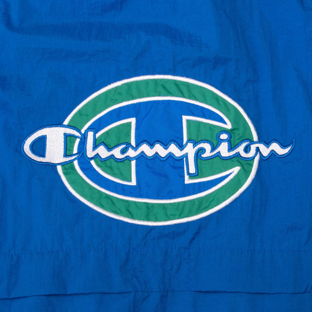 Close-up of large blue, green and white Champion back embroidery