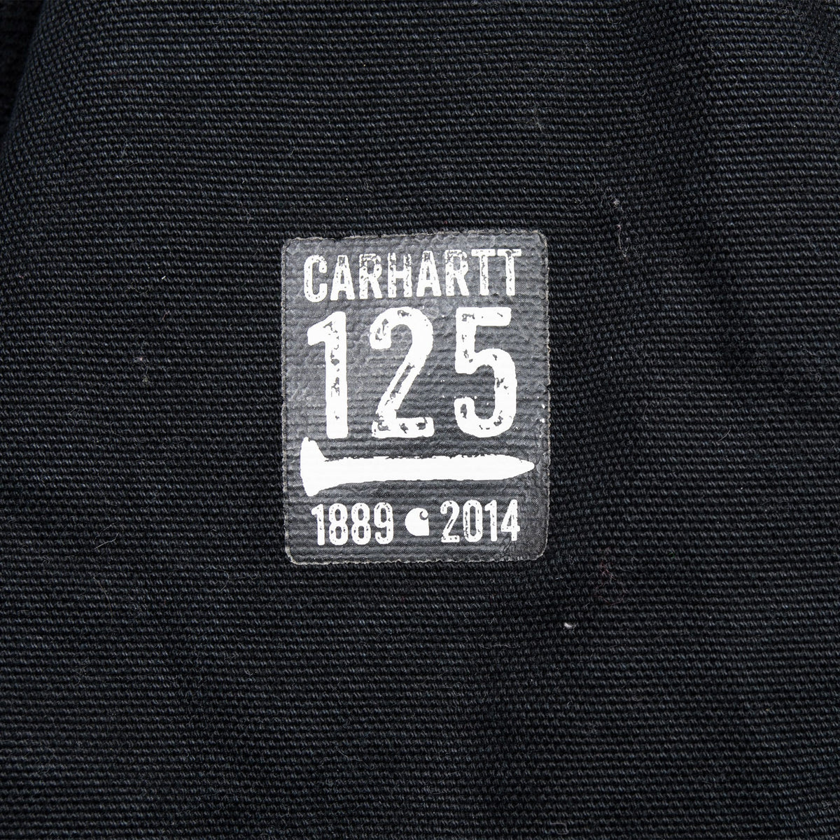 Carhartt 125 anniversary patch marked 1889–2014 on black lining