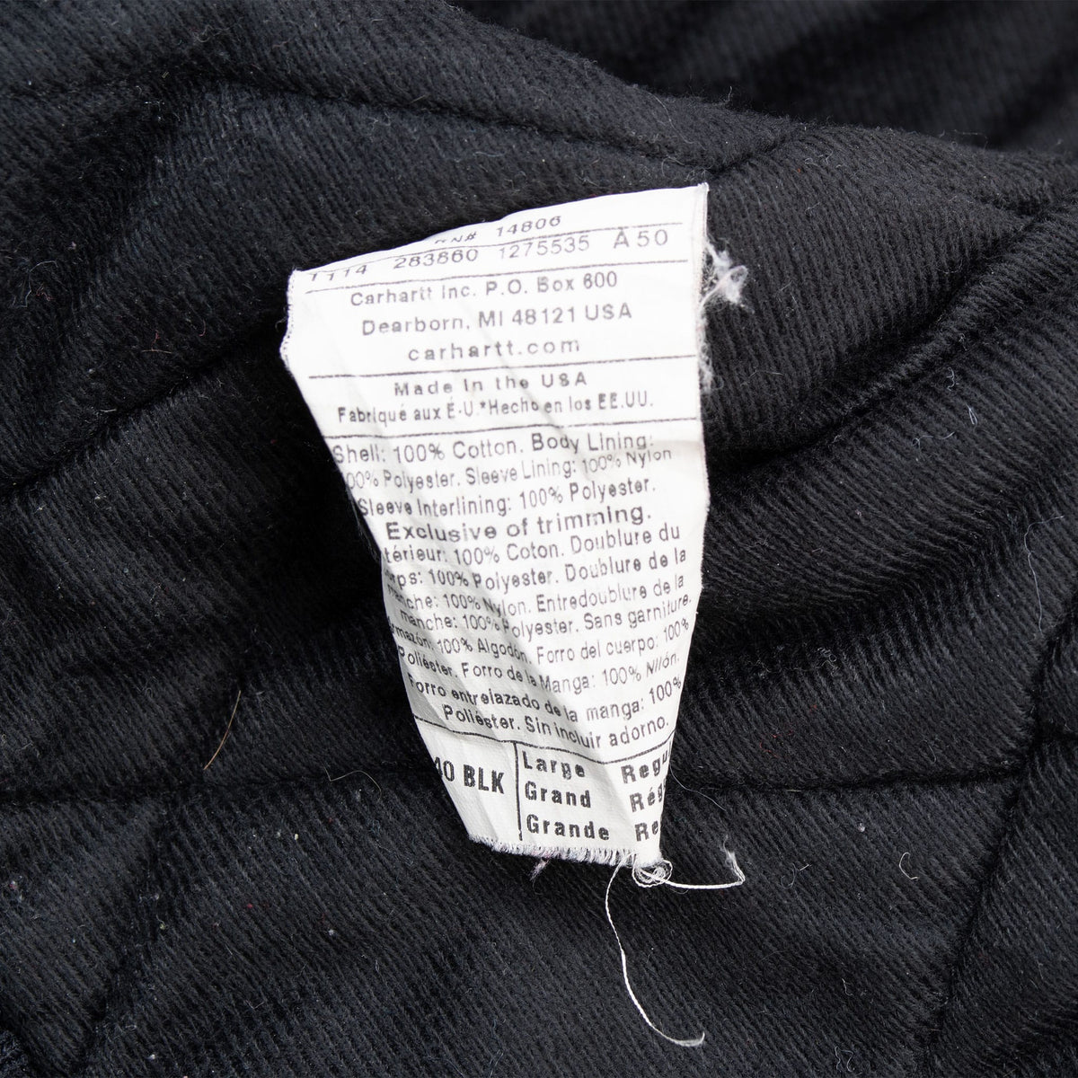 Interior care label on Carhartt J140BLK jacket showing size Large