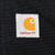 Close-up of Carhartt logo patch stitched on black fabric