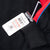 Attached NASCAR retail tag beside the jacket's black ribbed cuff and red sleeve panel
