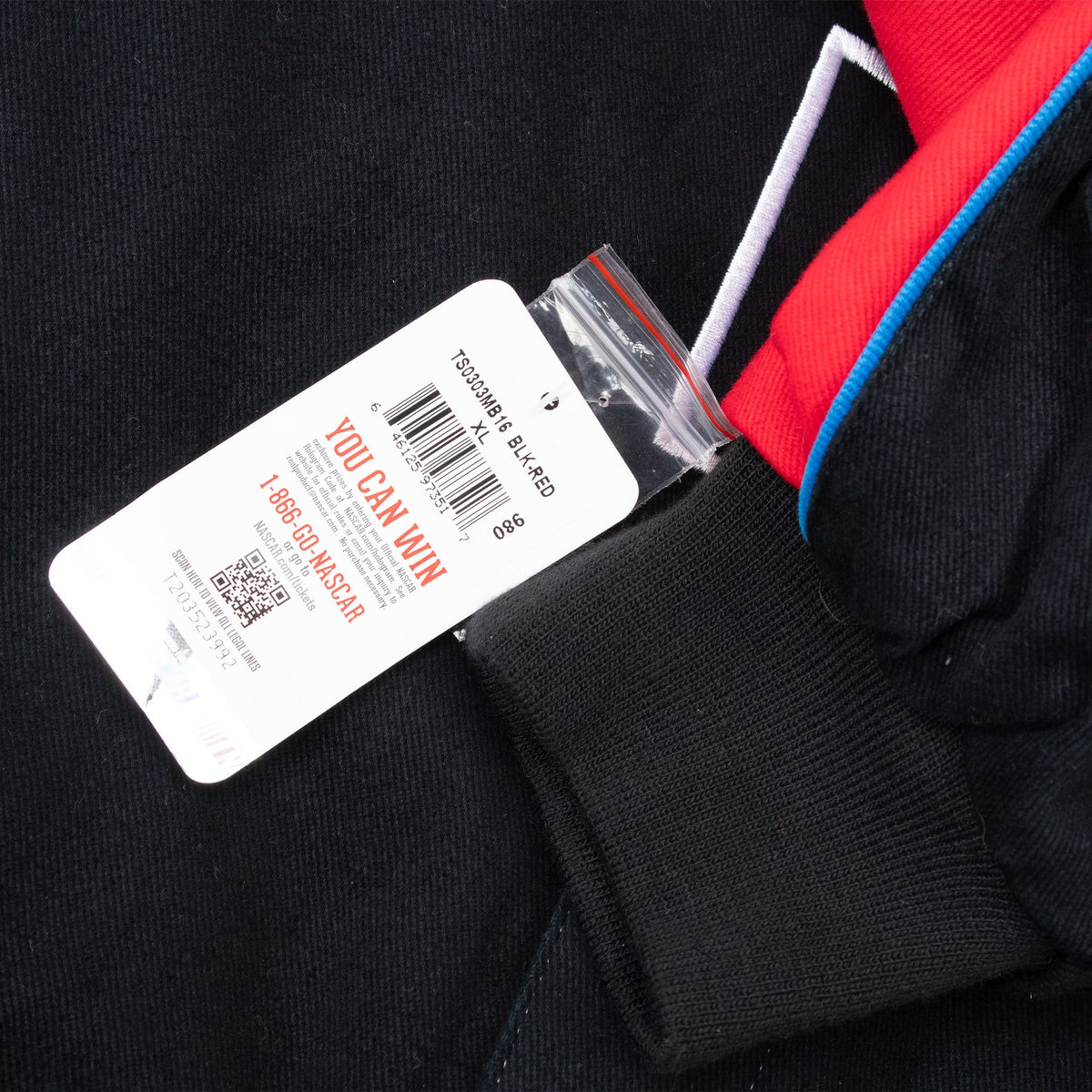 Attached NASCAR retail tag beside the jacket's black ribbed cuff and red sleeve panel