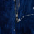Close-up of black front zipper and plush navy fleece with white star details