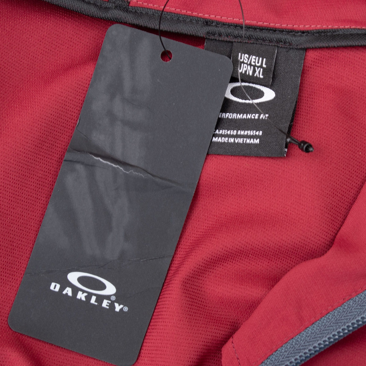 Oakley hangtag and interior size label inside burgundy pullover windbreaker