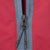 Close-up of gray half-zip closure and black corded zipper pull on burgundy Oakley windbreaker