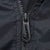 Close-up of black quarter-zip pull and zipper teeth on Nike windbreaker