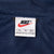 Nike XL neck label against navy mesh-textured lining
