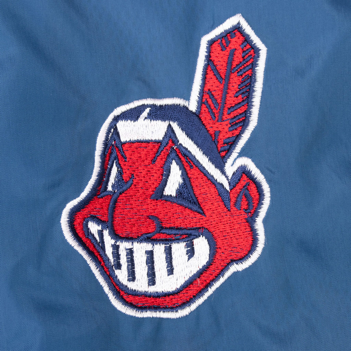 Close-up of embroidered Cleveland Indians logo on navy fabric