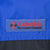 Close-up of Columbia Sportswear Company logo patch on blue jacket chest
