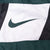 Close-up of green Nike Swoosh on white front chest panel
