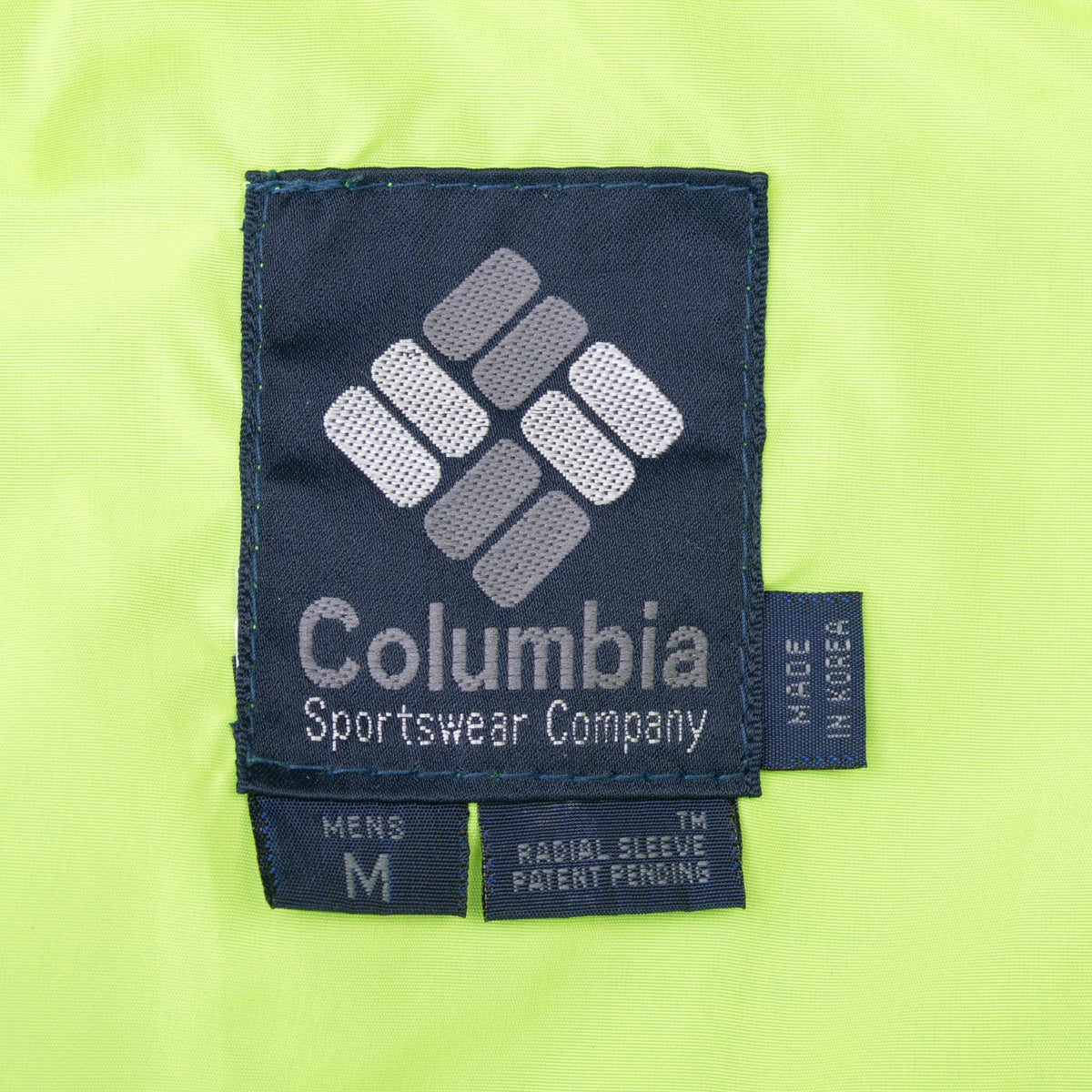 Columbia Sportswear Company interior label marked medium on neon green lining