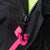 Close-up of covered black front zipper with bright pink zipper pulls