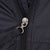 Close-up of branded metal zipper pull on black Nike ACG windbreaker