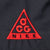 Close-up of red embroidered Nike ACG triangle logo on black fabric