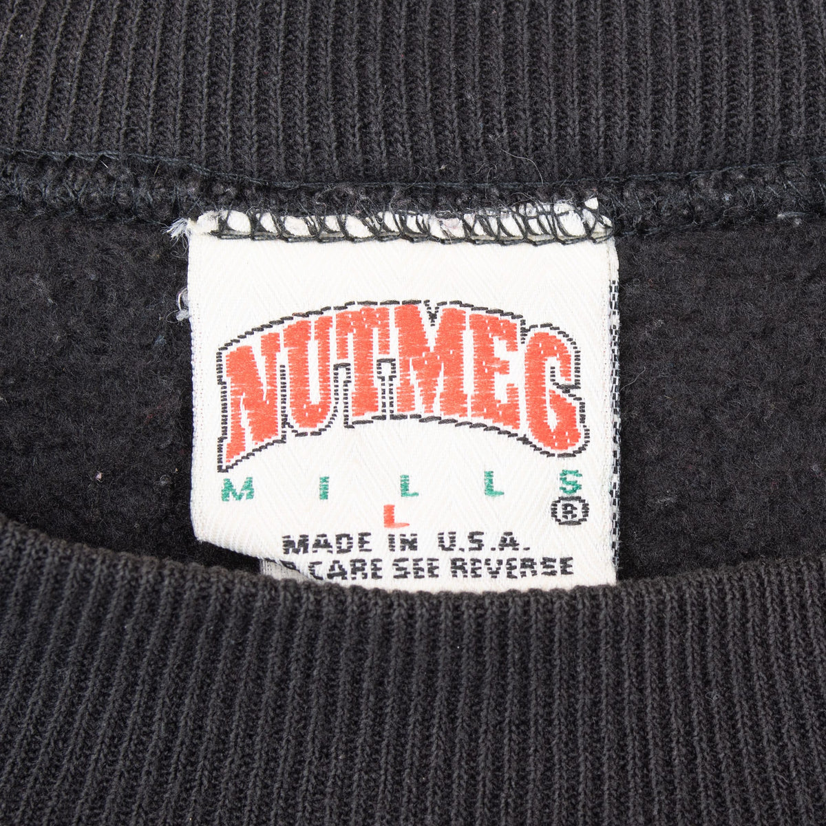 Nutmeg Mills neck label marked large and Made in USA on black sweatshirt