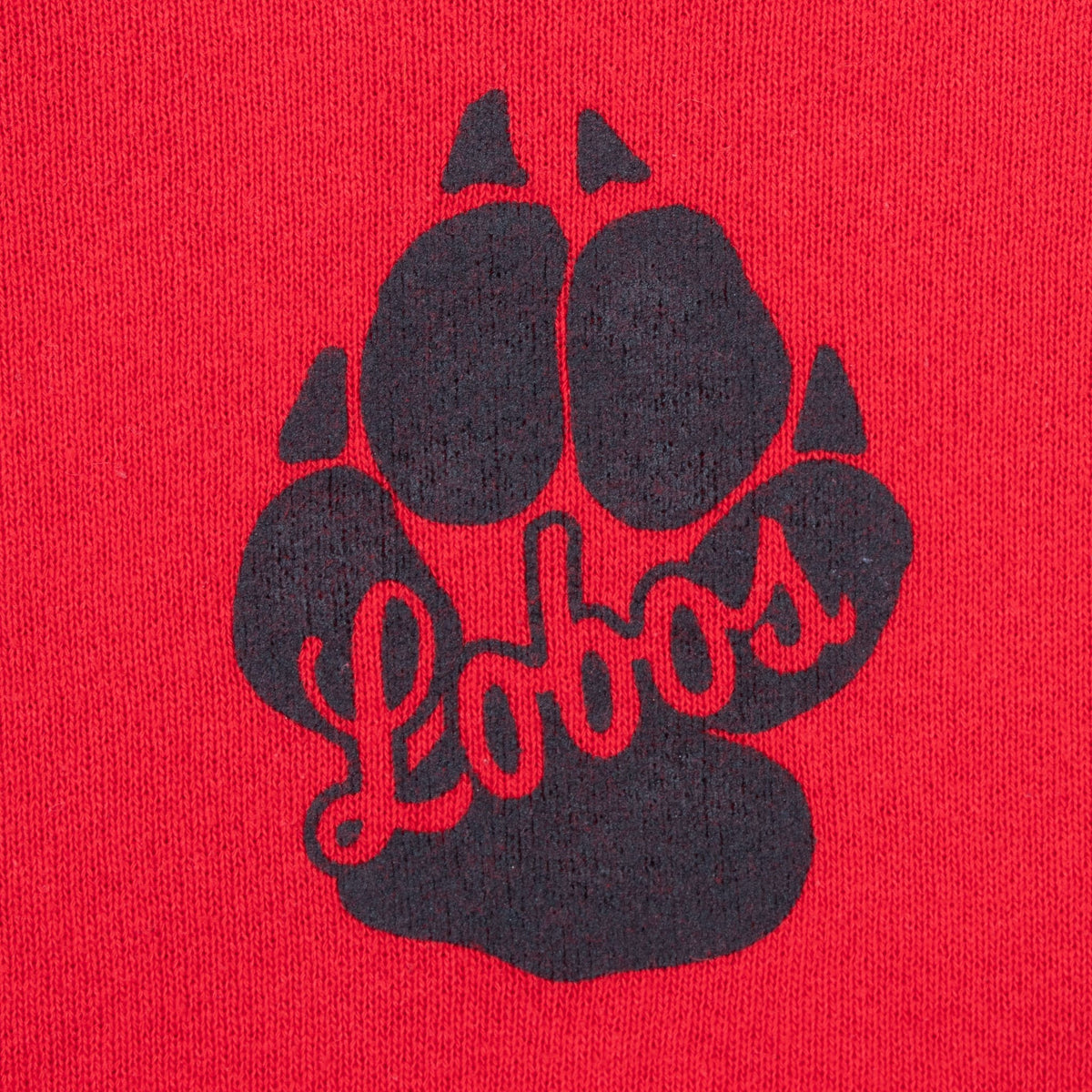 Close-up of black Lobos paw-print graphic on upper back