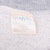 Close-up of faded interior Disney sweatshirt neck tag