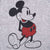 Close-up of seated Mickey Mouse graphic in black, red and white